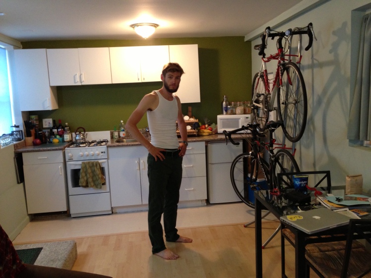 chris hanging our bikes with care. in the kitchen.